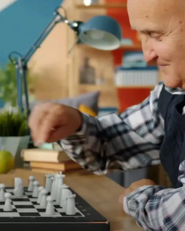 A grandfather playing GoChess with his grandson